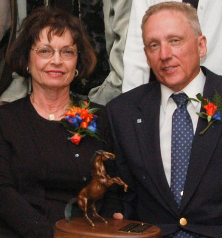 Two smiling donors wearing corsages.