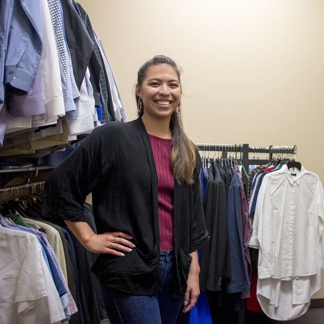 A woman poses in a closet