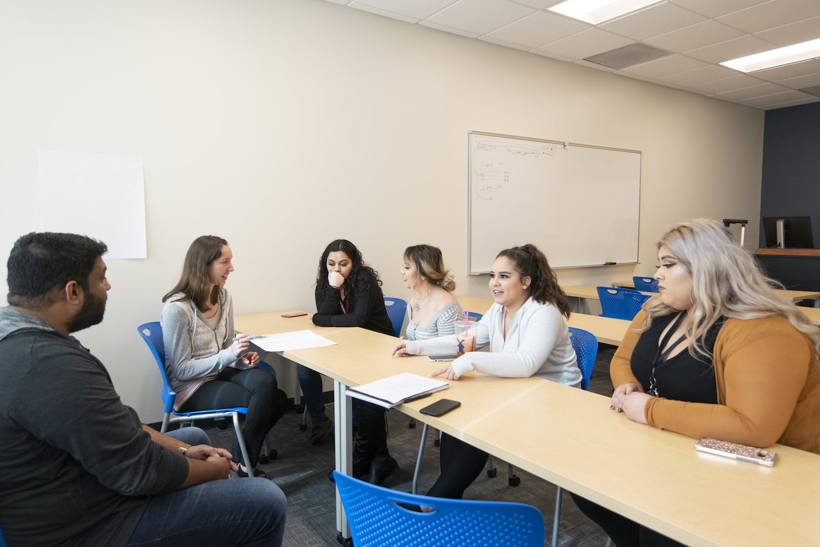 teens sitting at desks in a classroom