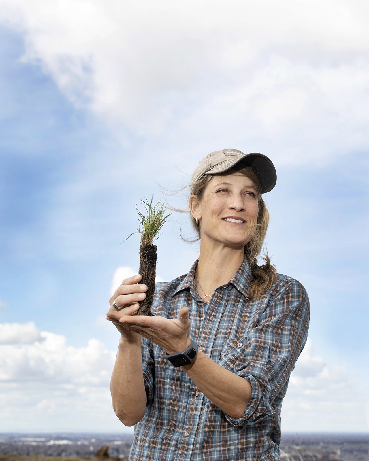 Martha Brabec showing a bunch grass seedling ready to be planted.