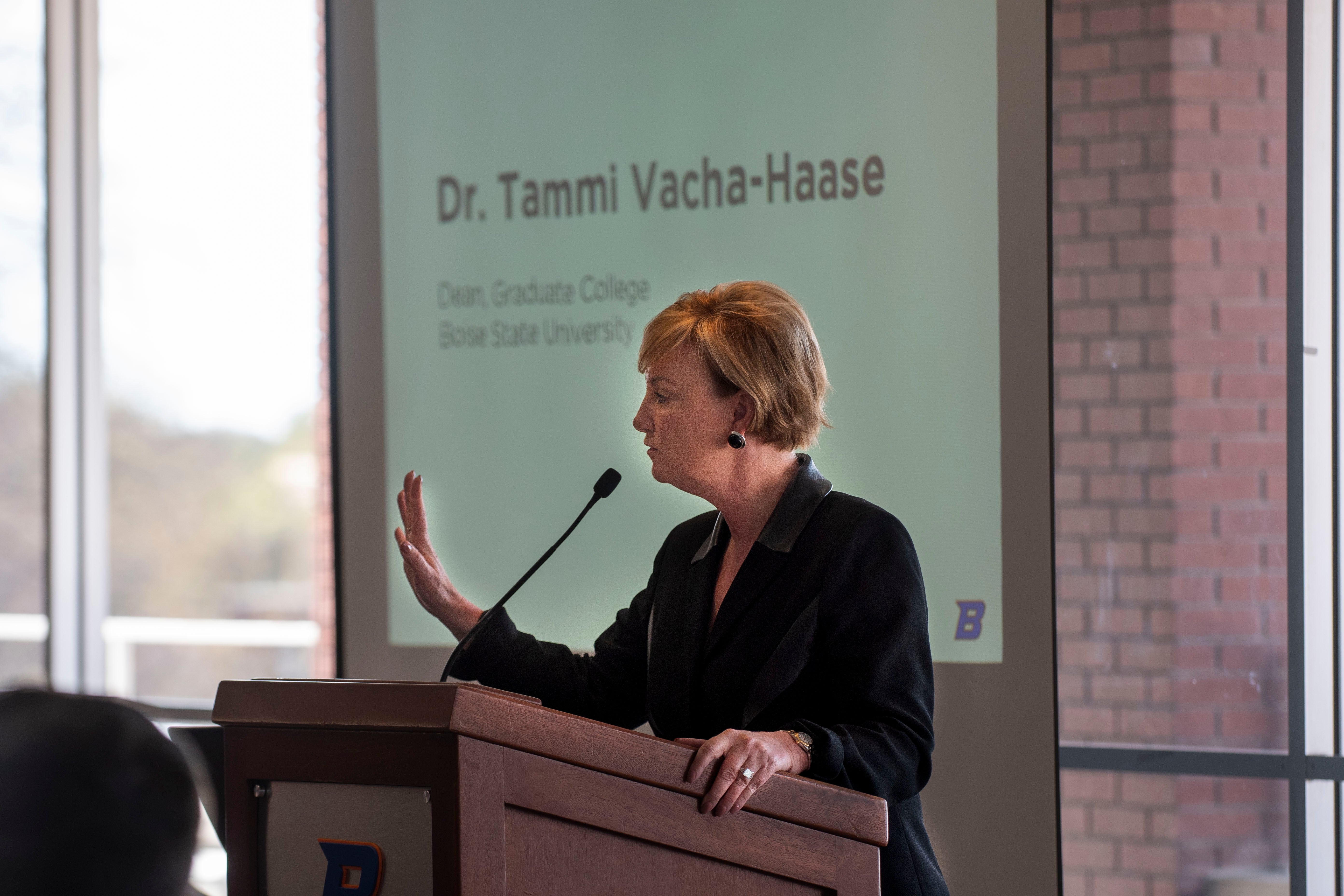 Dean Tammi Vacha-Haase welcoming guests at podium 