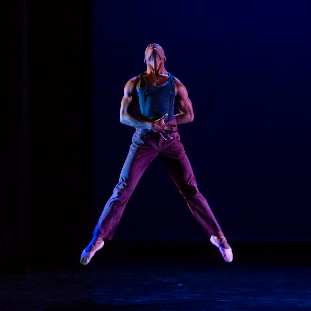 A dancer jumps up in the air