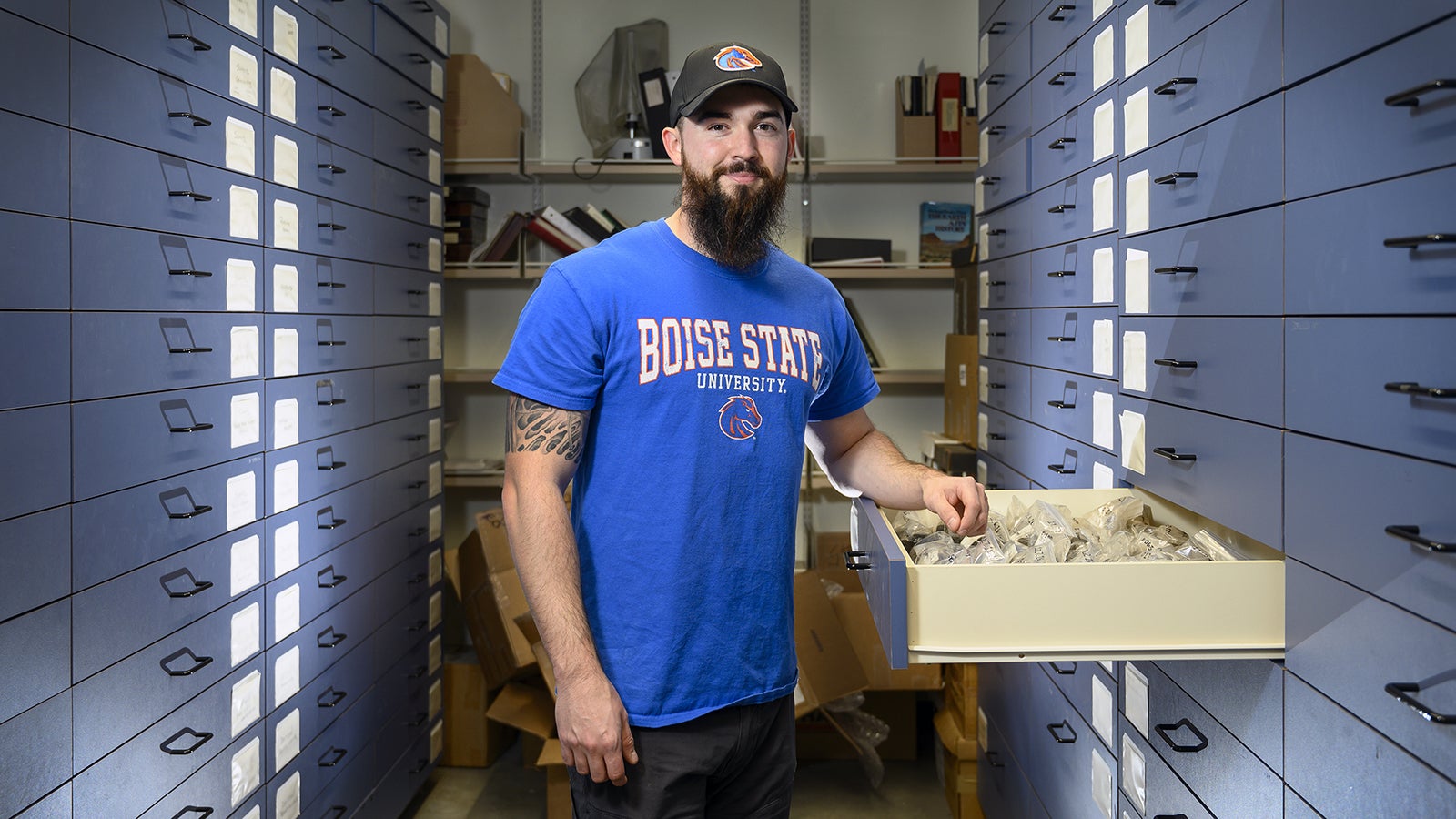 Aaron Marshall in shelves of magma samples