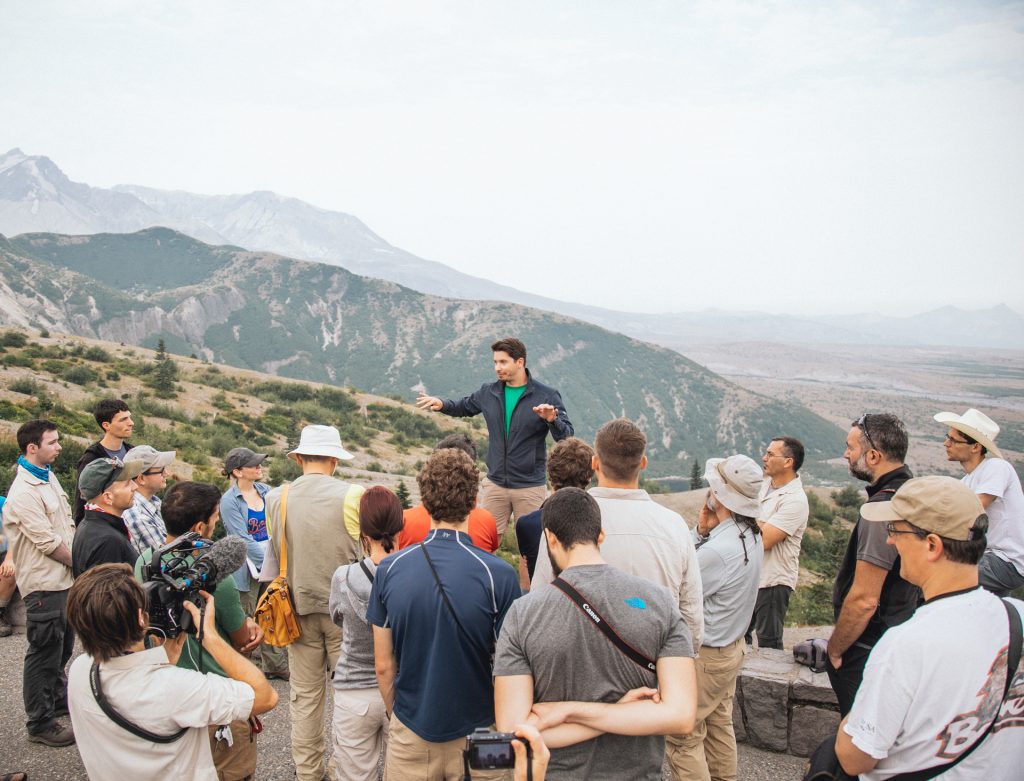 Photo of Nick Pollock speaking to large group of students outside