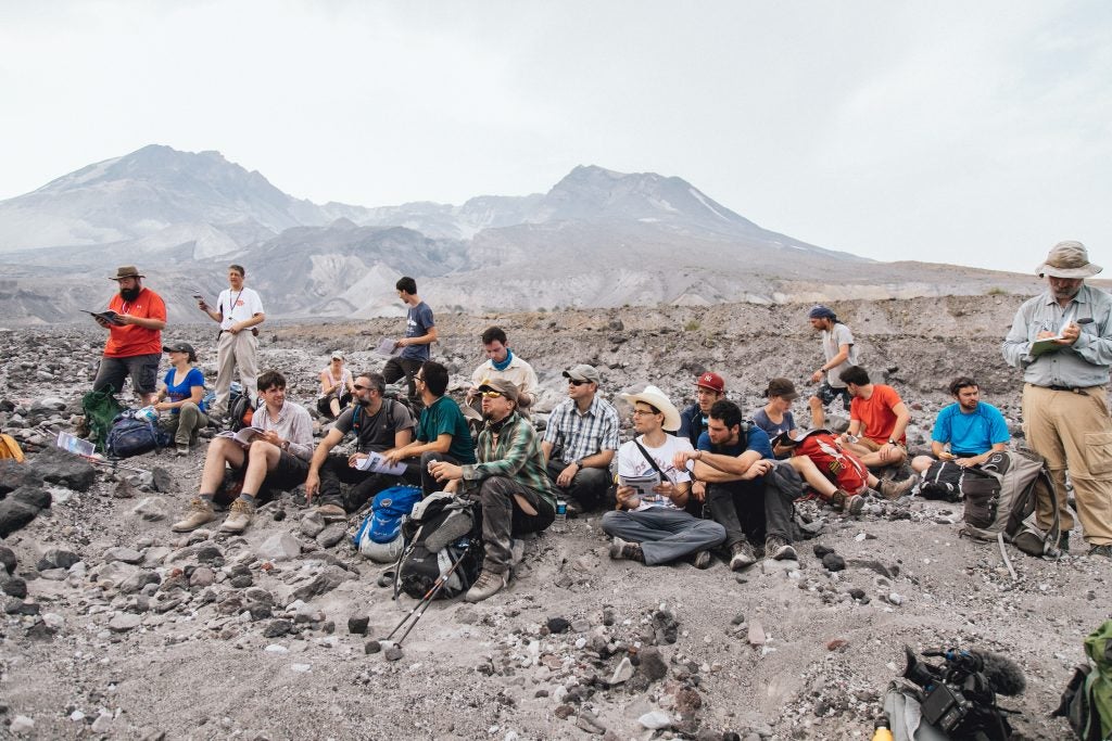 group of students sitting on ground