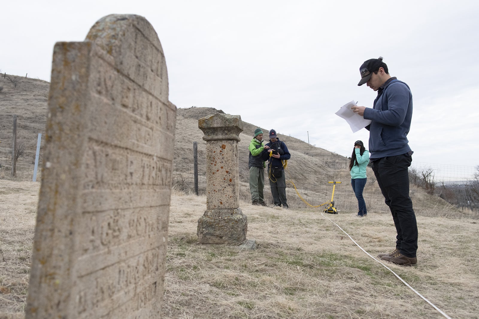 A tombstone and geophysics students conducting research