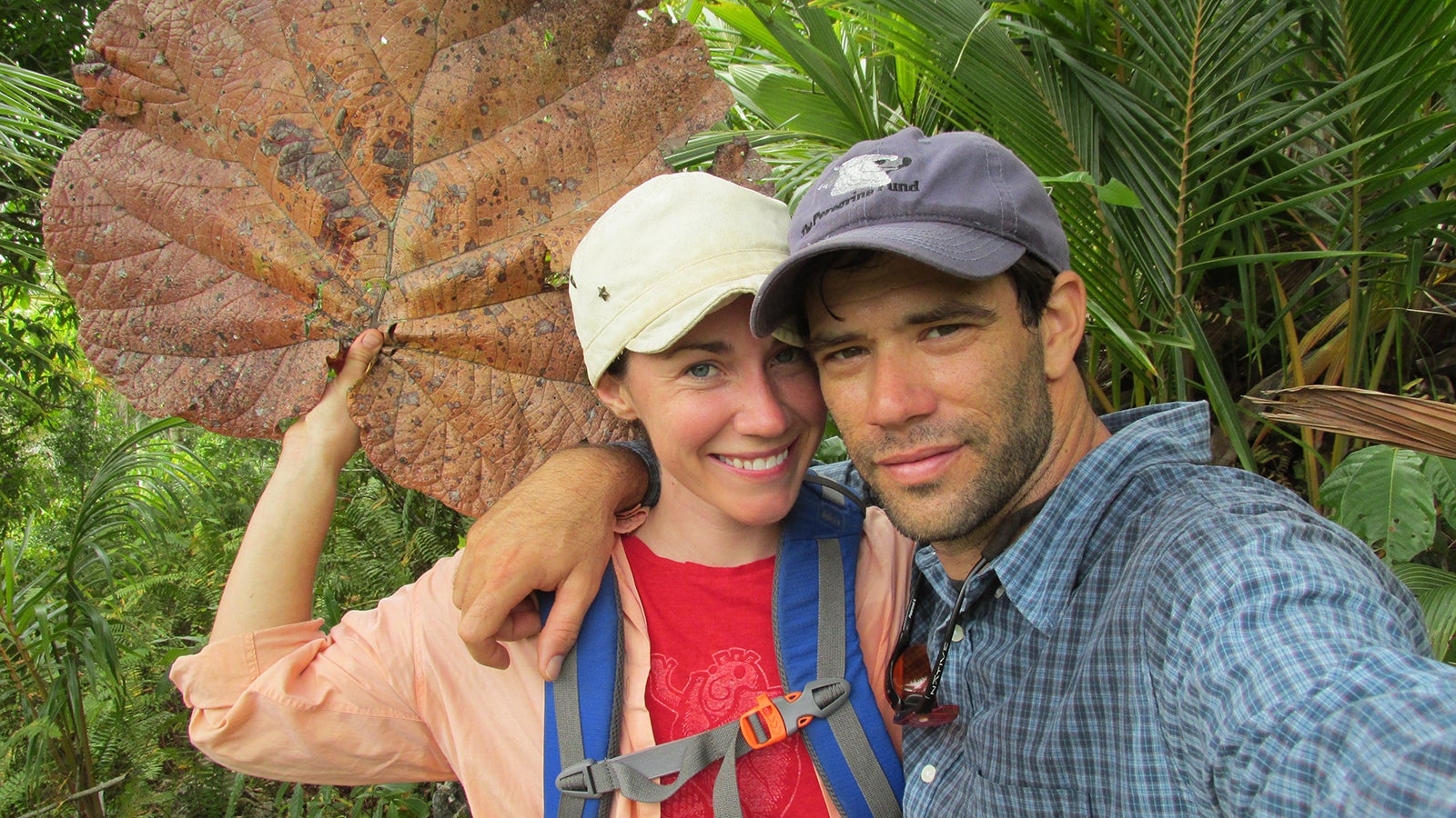 Photo of Christine and Thomas in Dominican Republic. Christine is holding an enormous leaf
