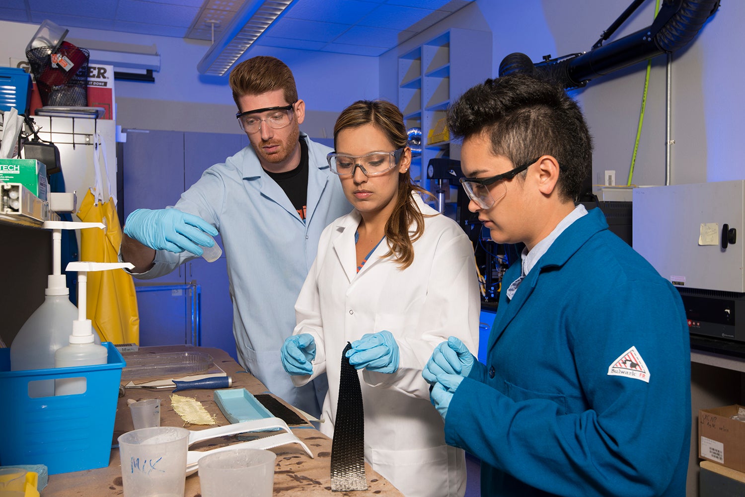 Photo of three people working in lab