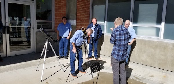 Kirk Long with students and telescope