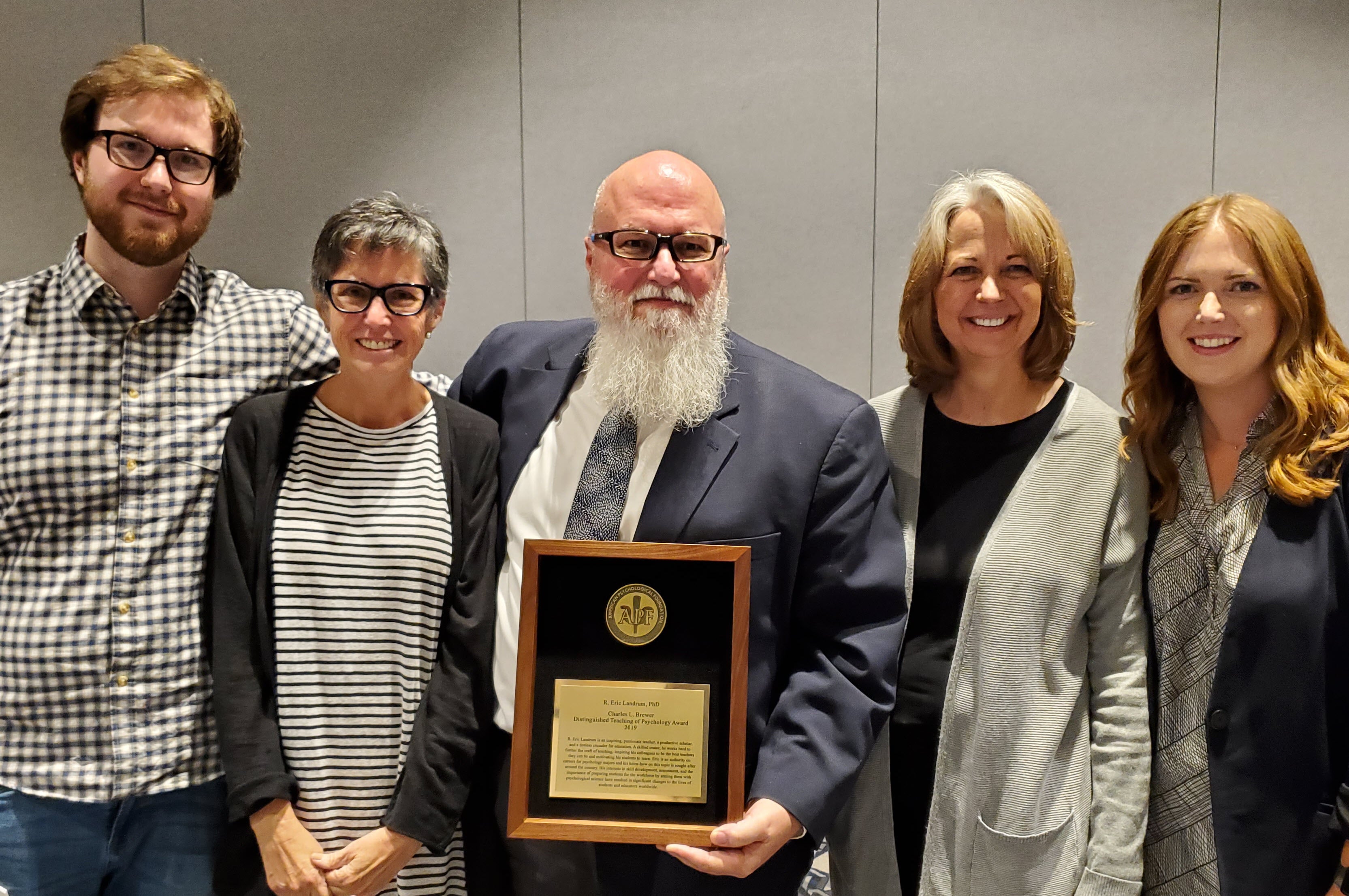 Landrum awarded plaque, surrounded by family