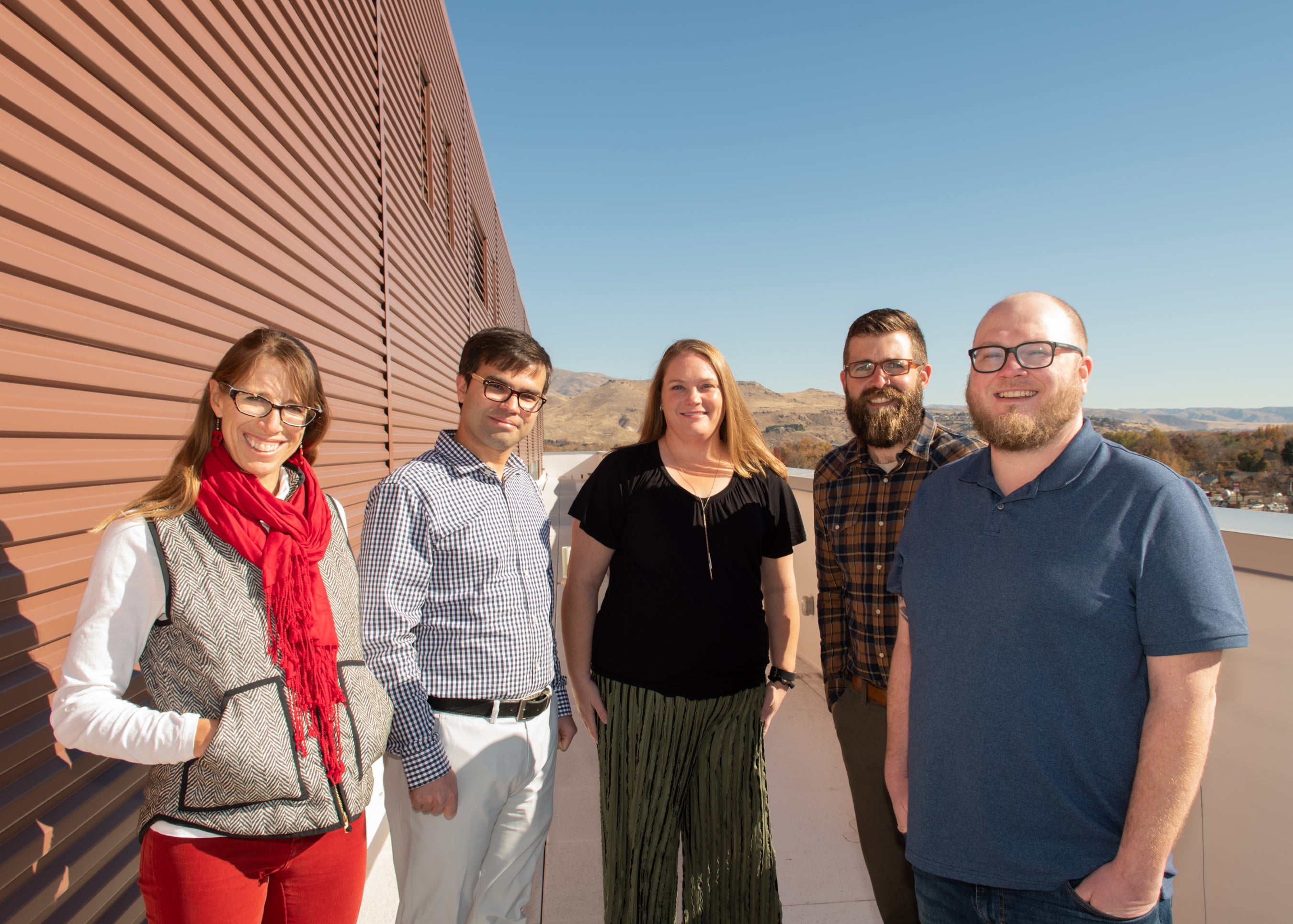 Group photo of interdisciplinary team on rooftop