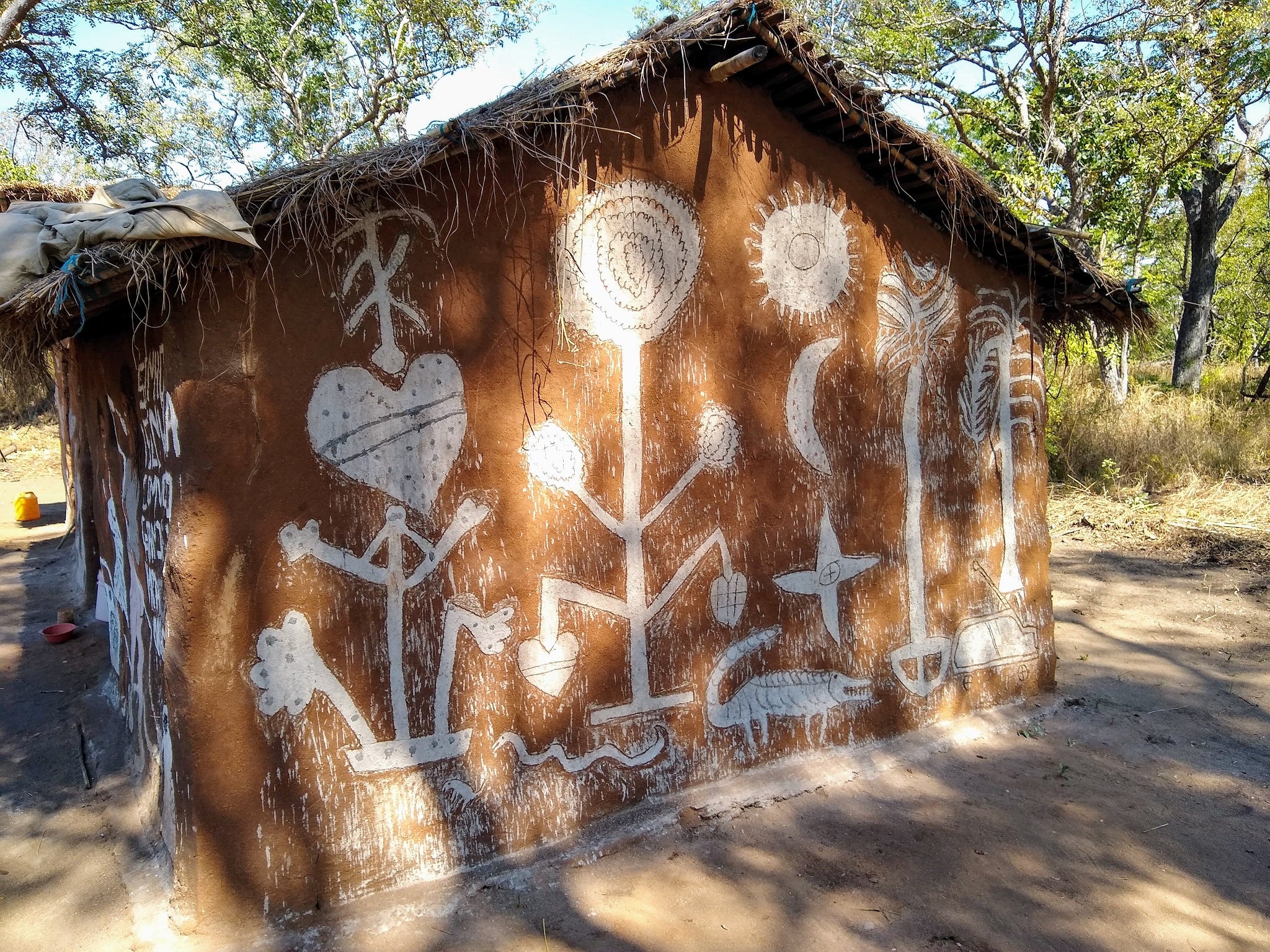 Fertility and protective symbols are painted on side of house in Mozambique