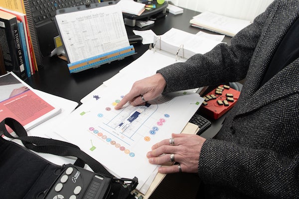 Don Winiecki in his office with maps of the Main Street Station. 