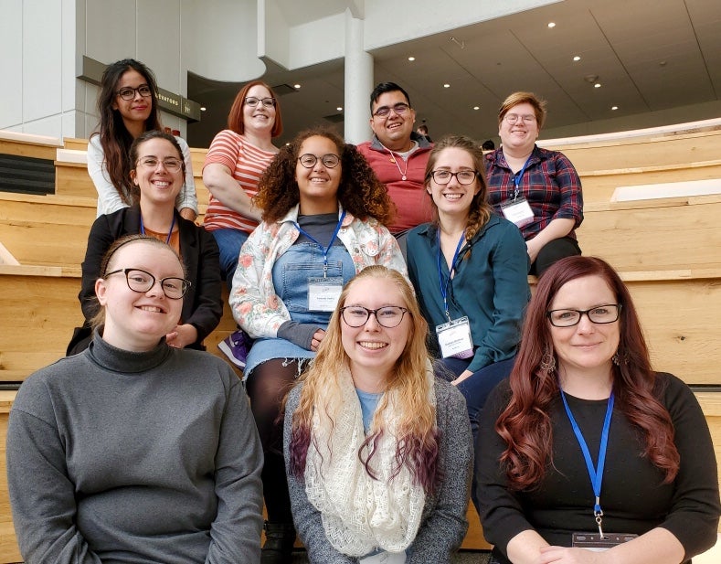 Writing Center staff and students pose on steps