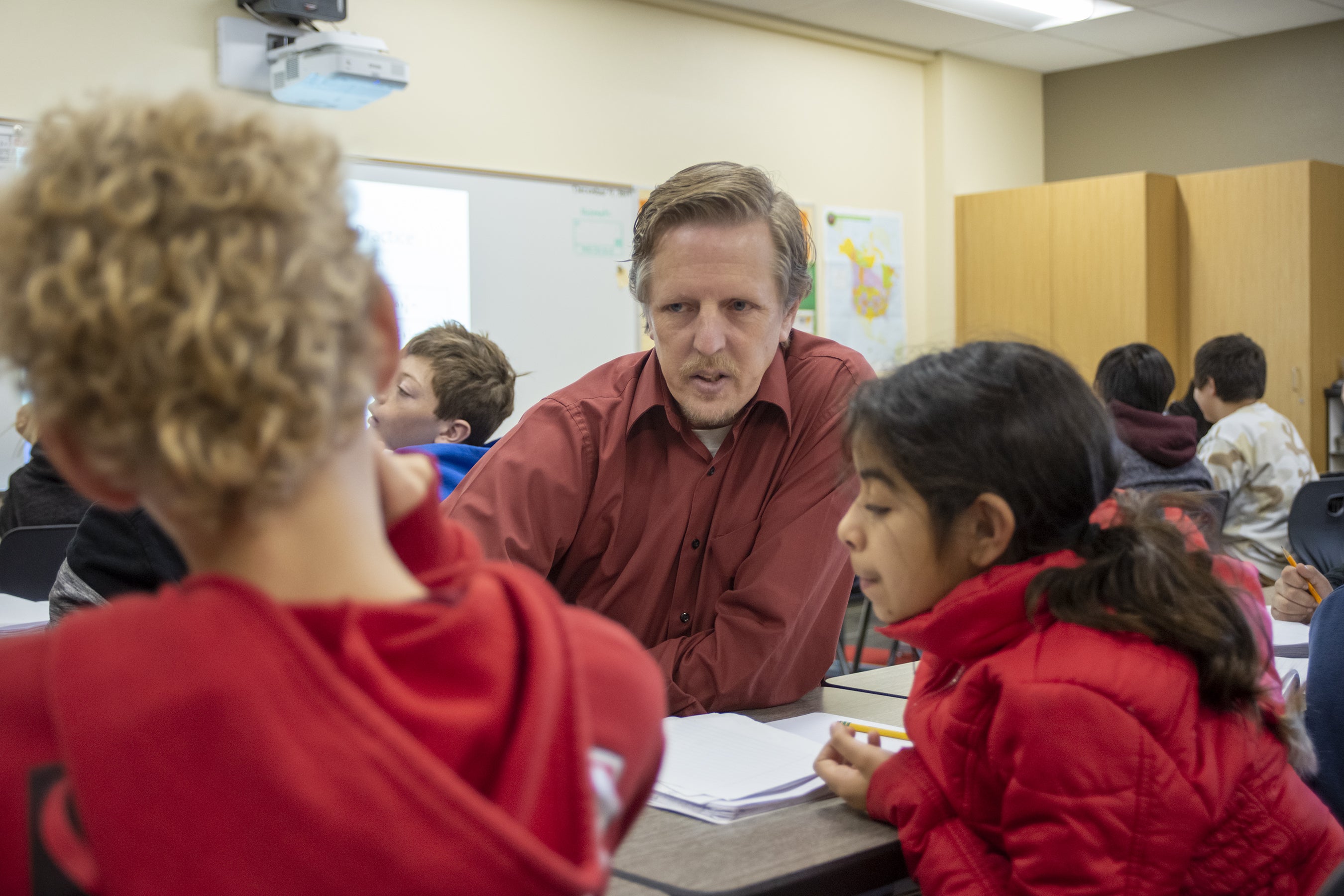 A teacher works with his students