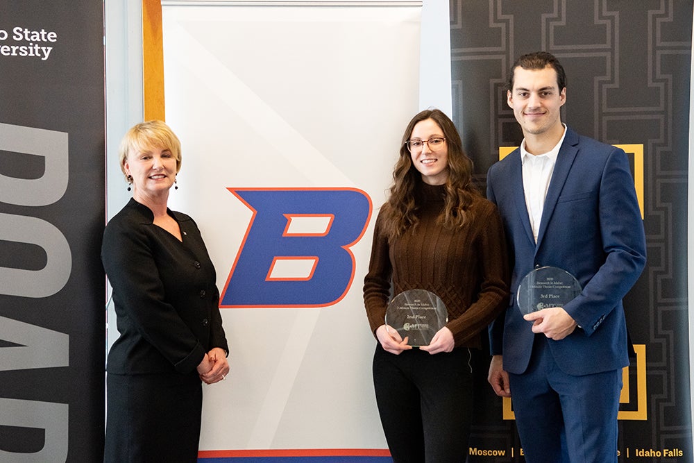 Dean and winning students stand with awards