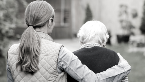 woman helping elderly person