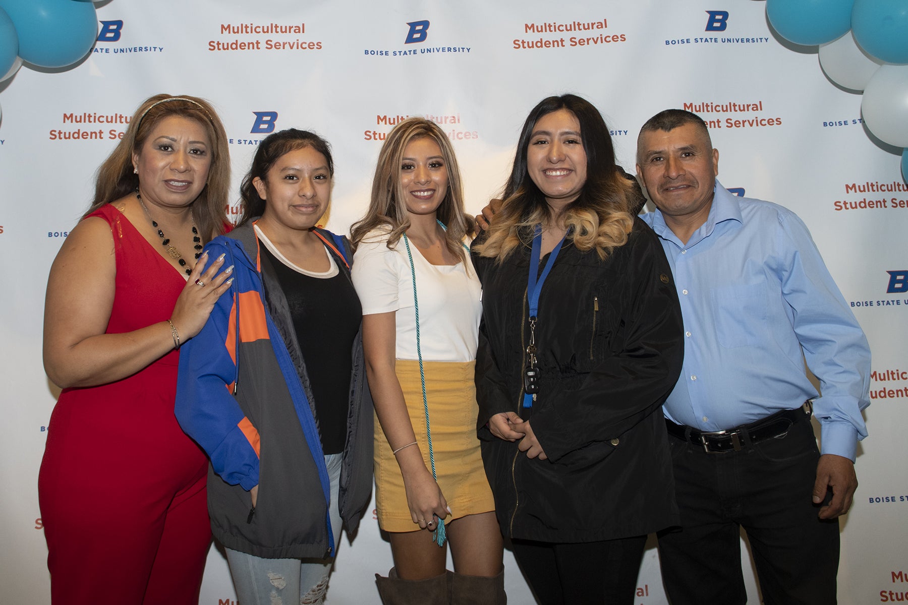 Family pose together at a first-gen cording event