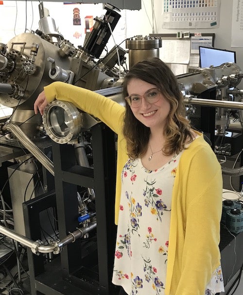 Katie standing by MBE machine