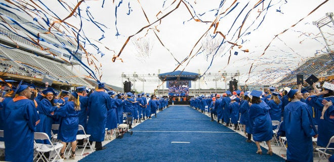 Spring commencement ceremony on the blue turf