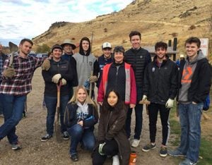 cobe living-learning community members planting sage brush along table rock trail
