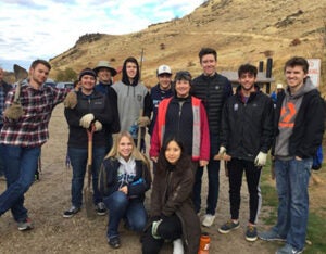 cobe living-learning community members planting sage brush along table rock trail