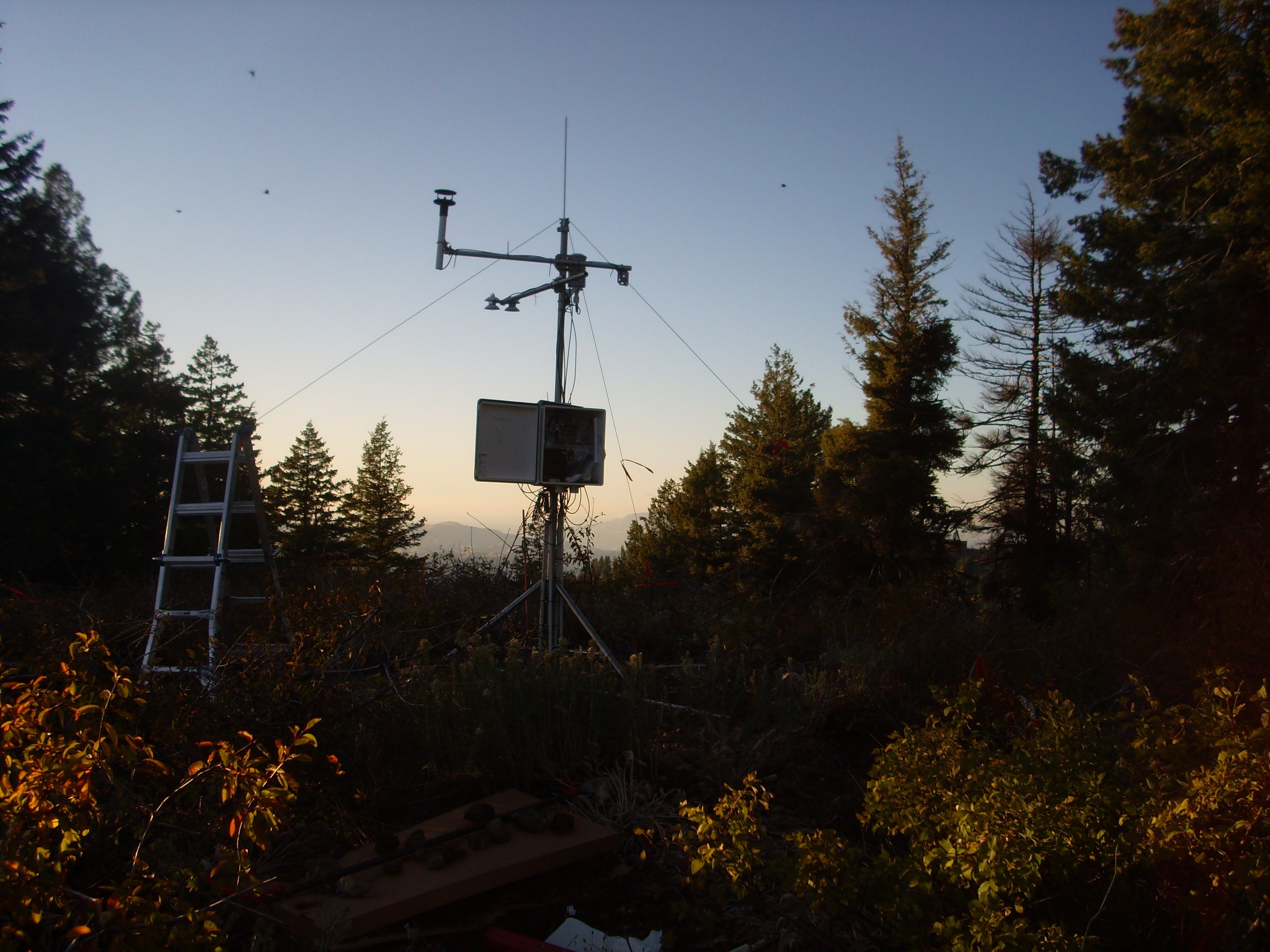 equipment on hill during sunset