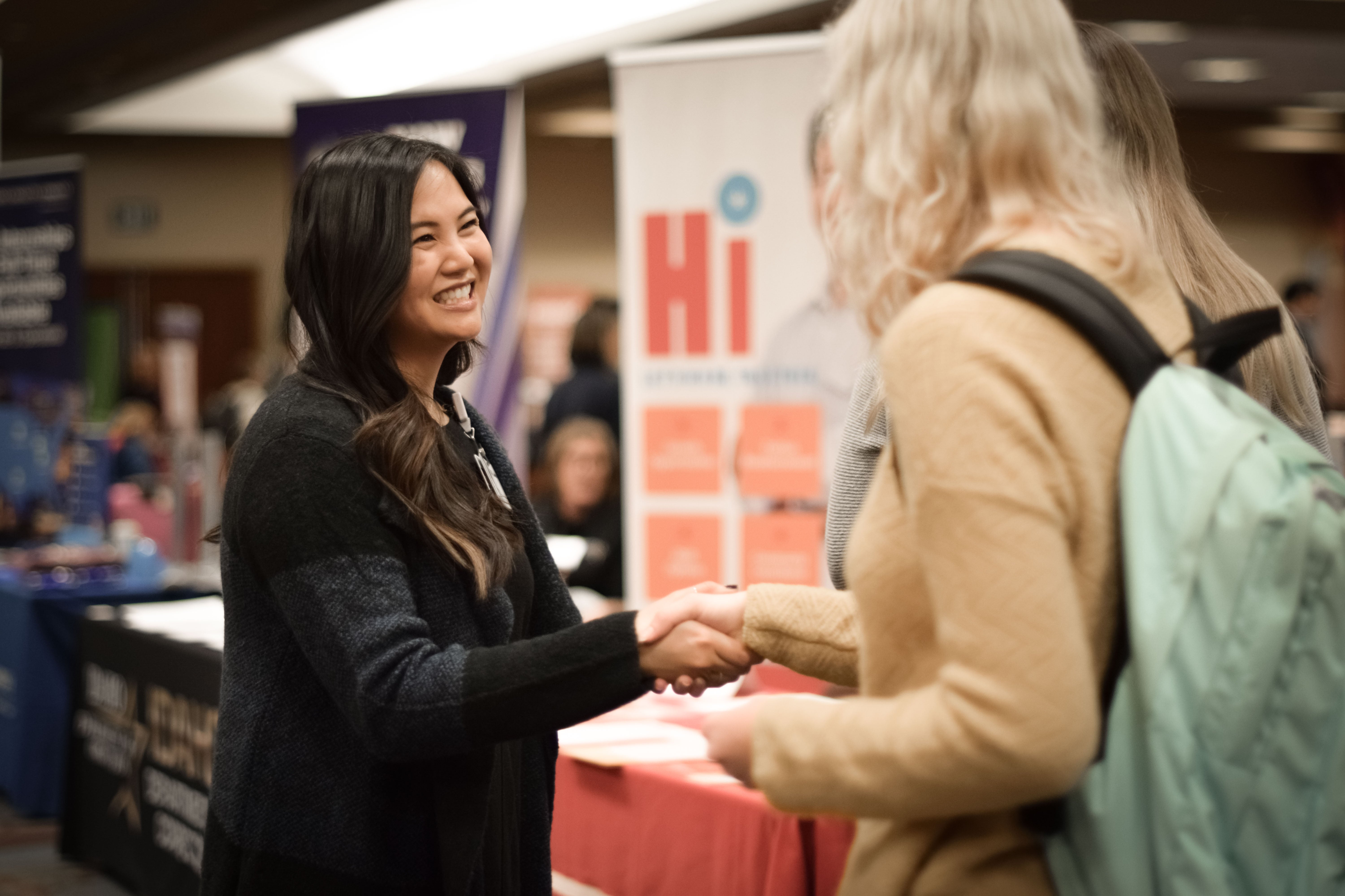 Student shaking hands with employer at career fair