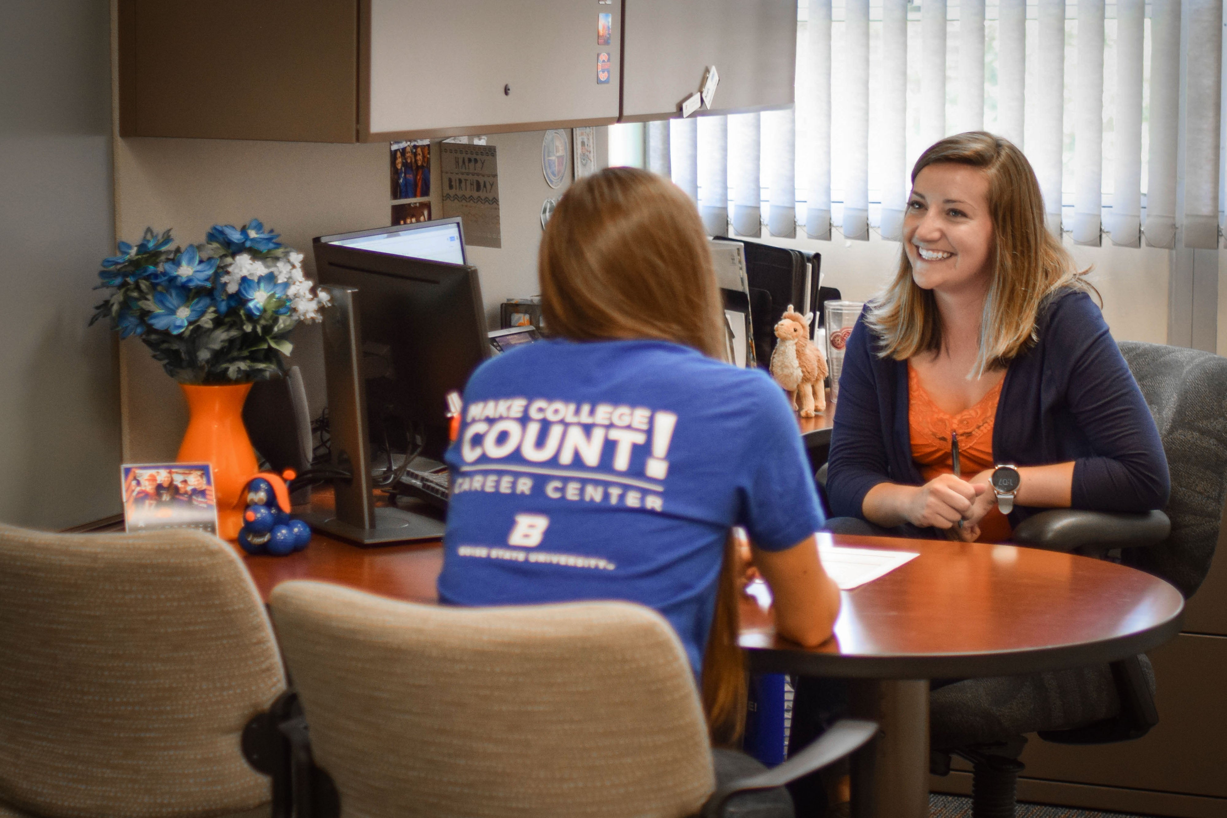 Student meeting with career counselor in an office