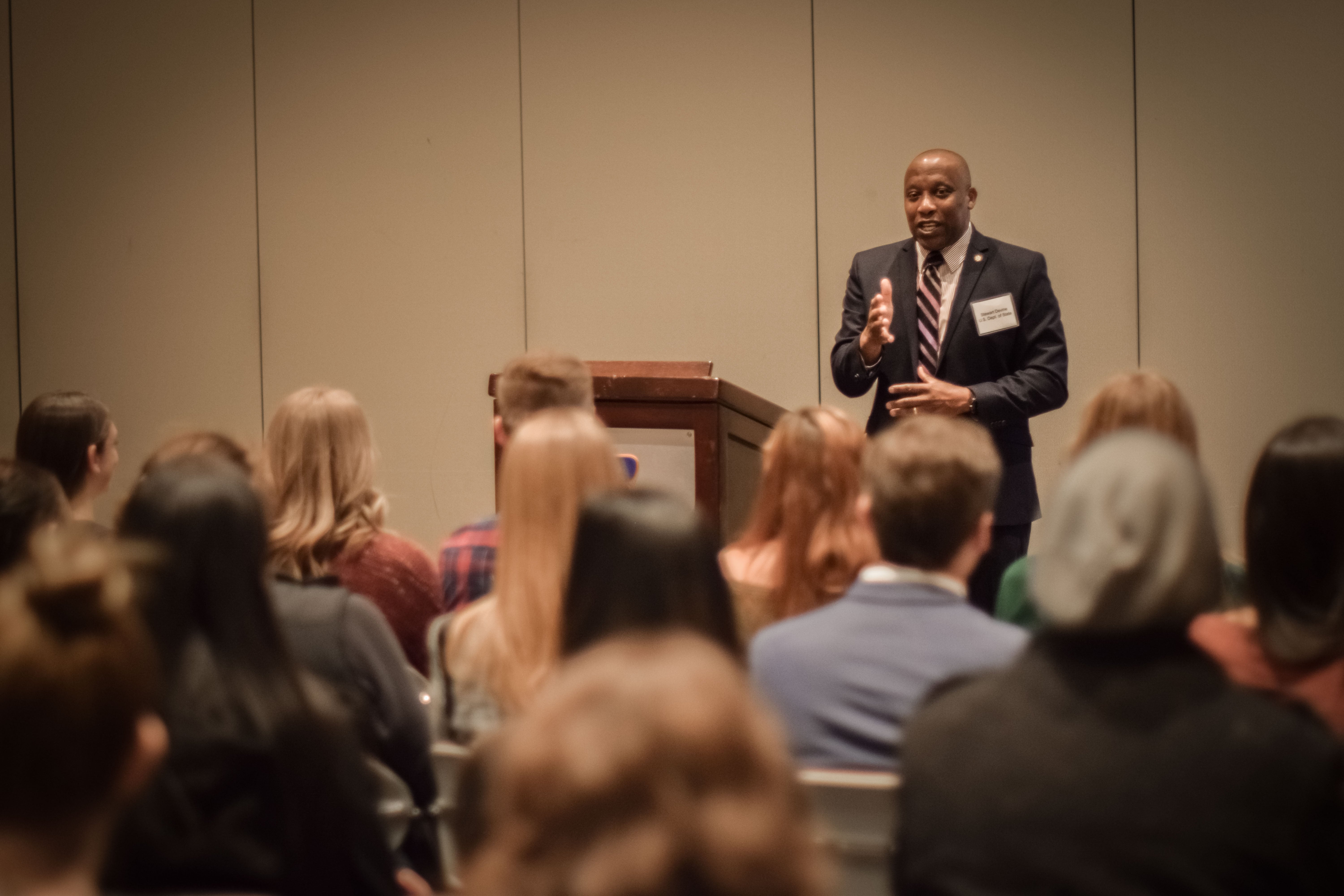 Students watching FBI representative speak in a ballroom