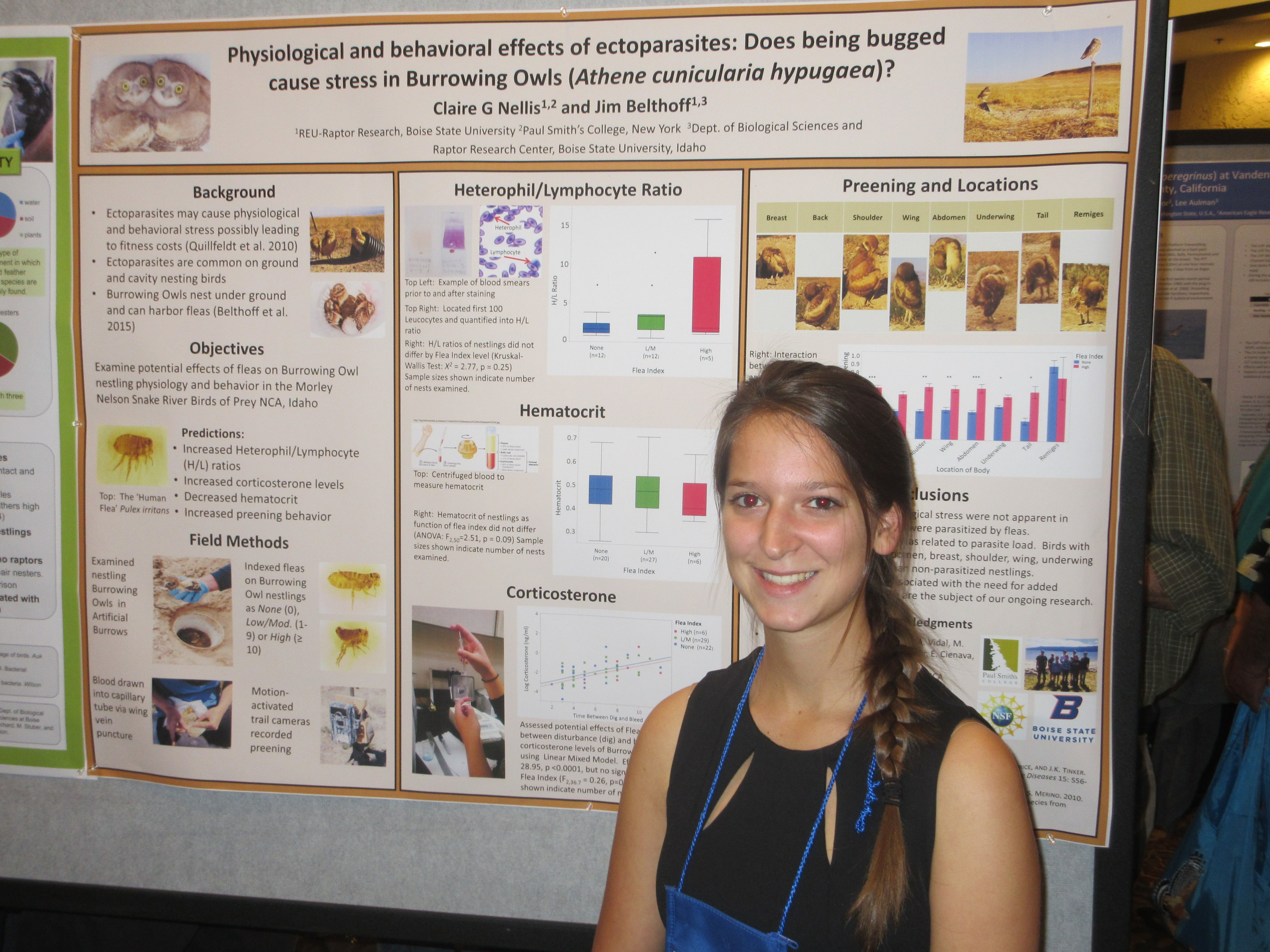 Student smiling in front of academic poster presentation