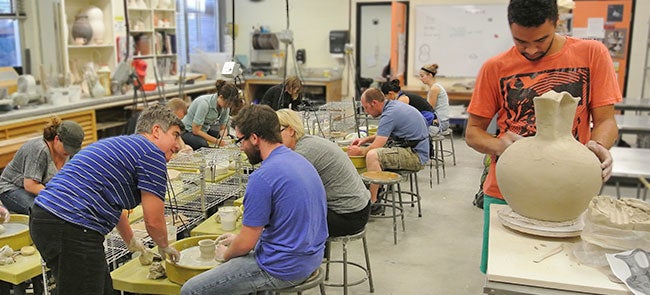 students in a pottery class