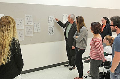 Students and faculty reviewing graphics