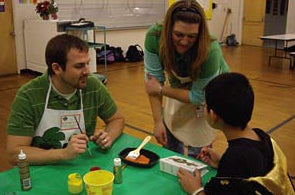 students painting with child