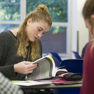 student looking through a text book