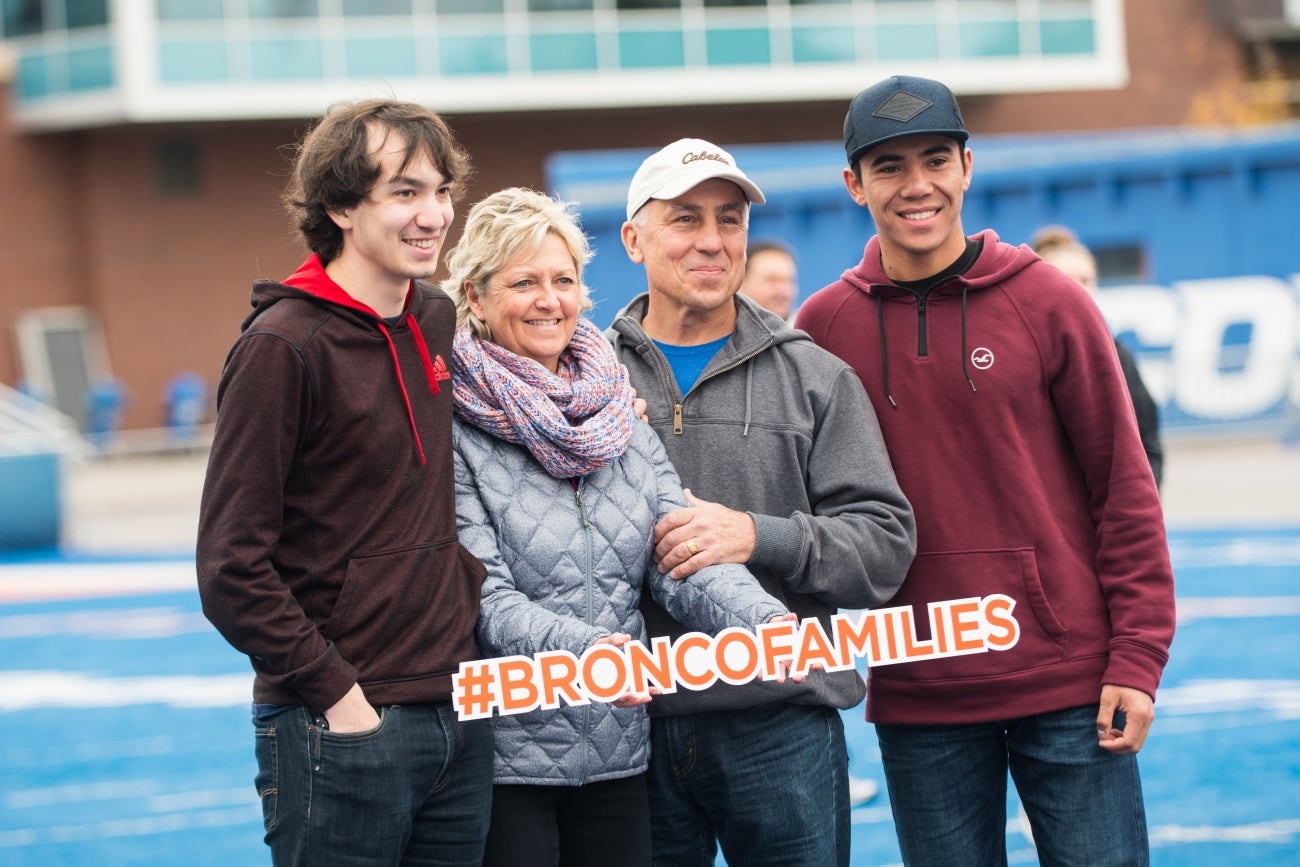 Family on blue turf