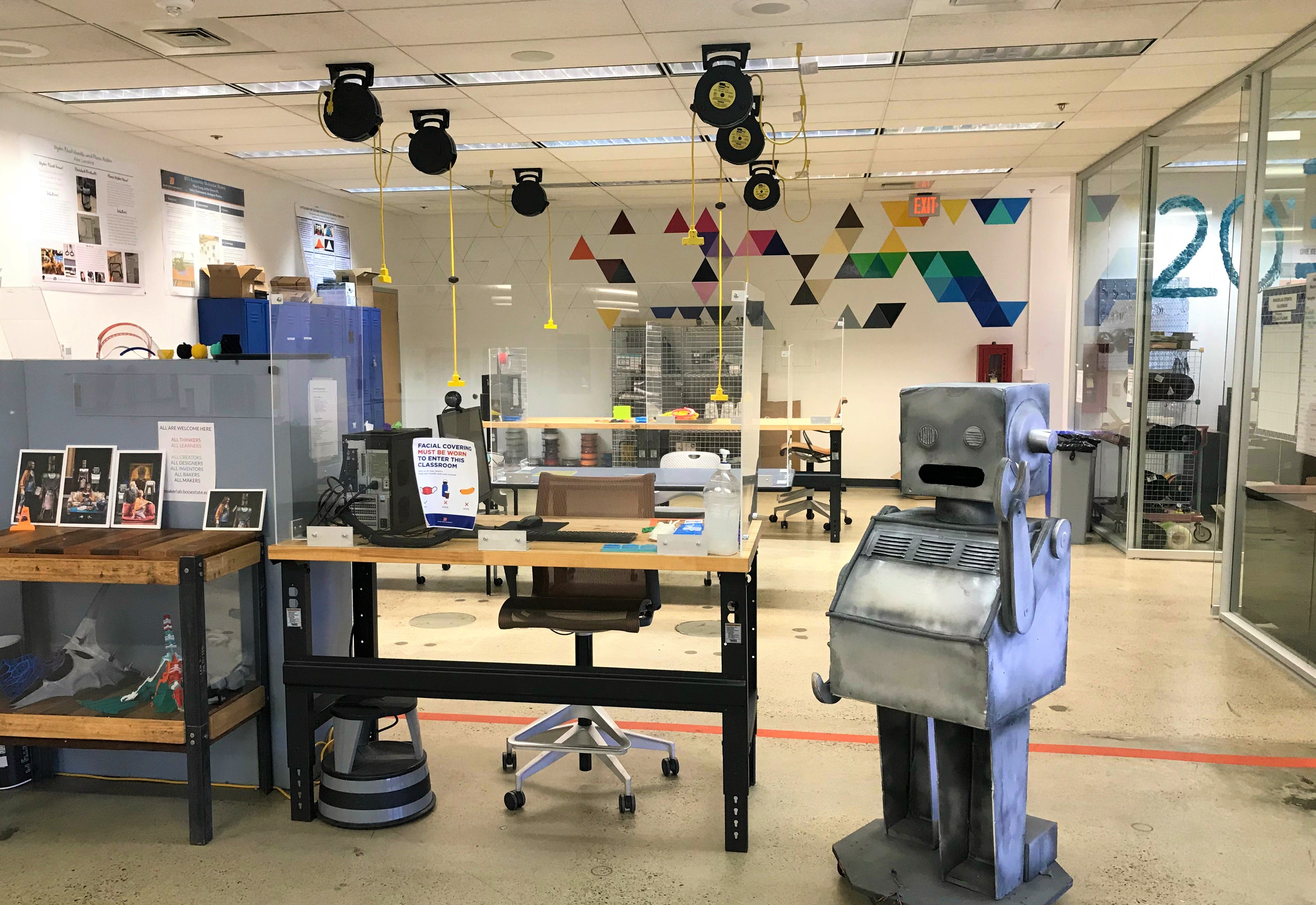 MakerLab front reception desk, display case with 3D prints, and a 4-foot tall silver wooden robot.