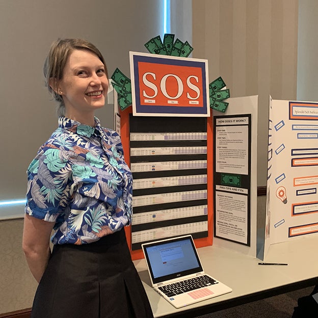 Kristen Batten standing in front of poster