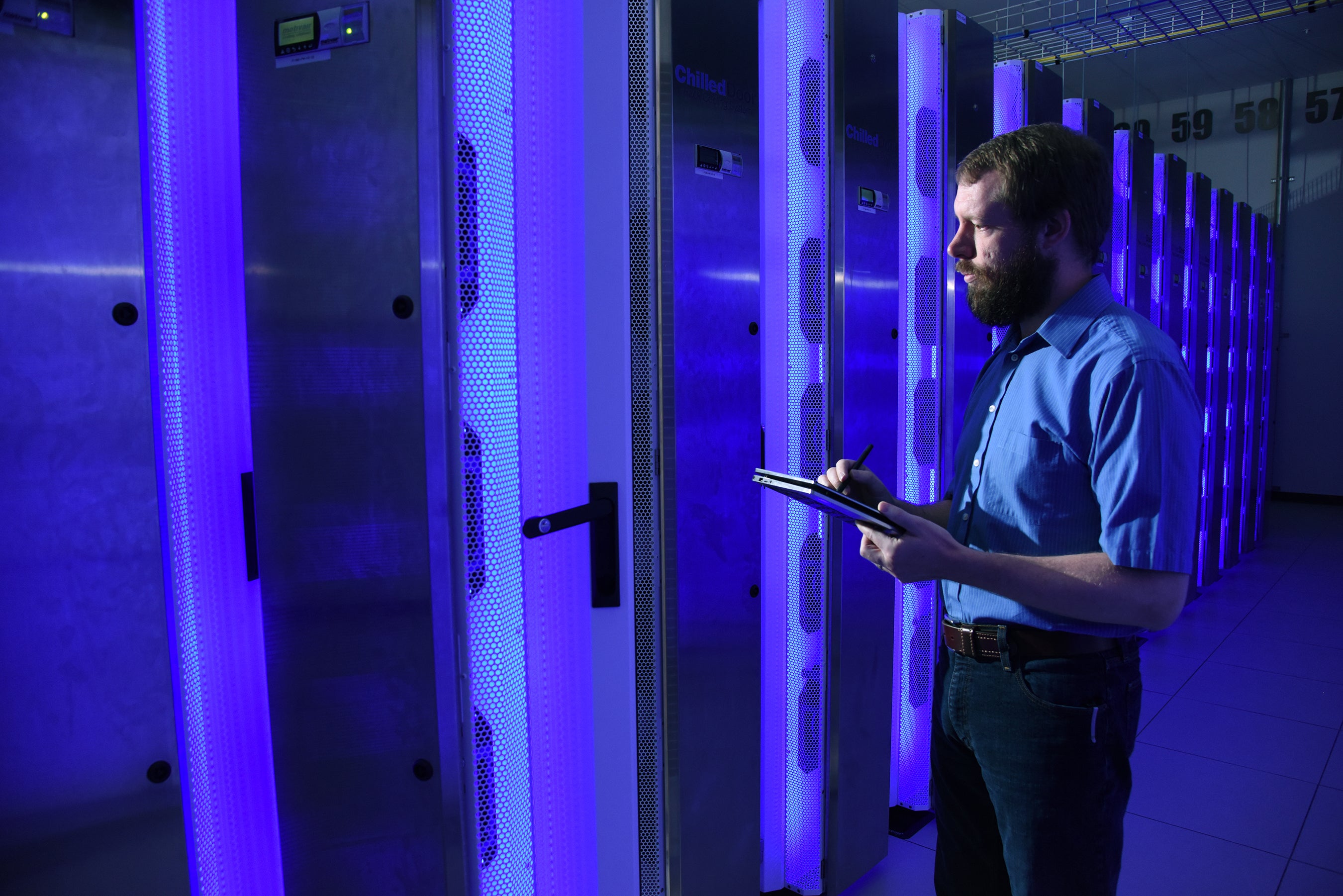 HPC Personnel Looking at Supercomputer