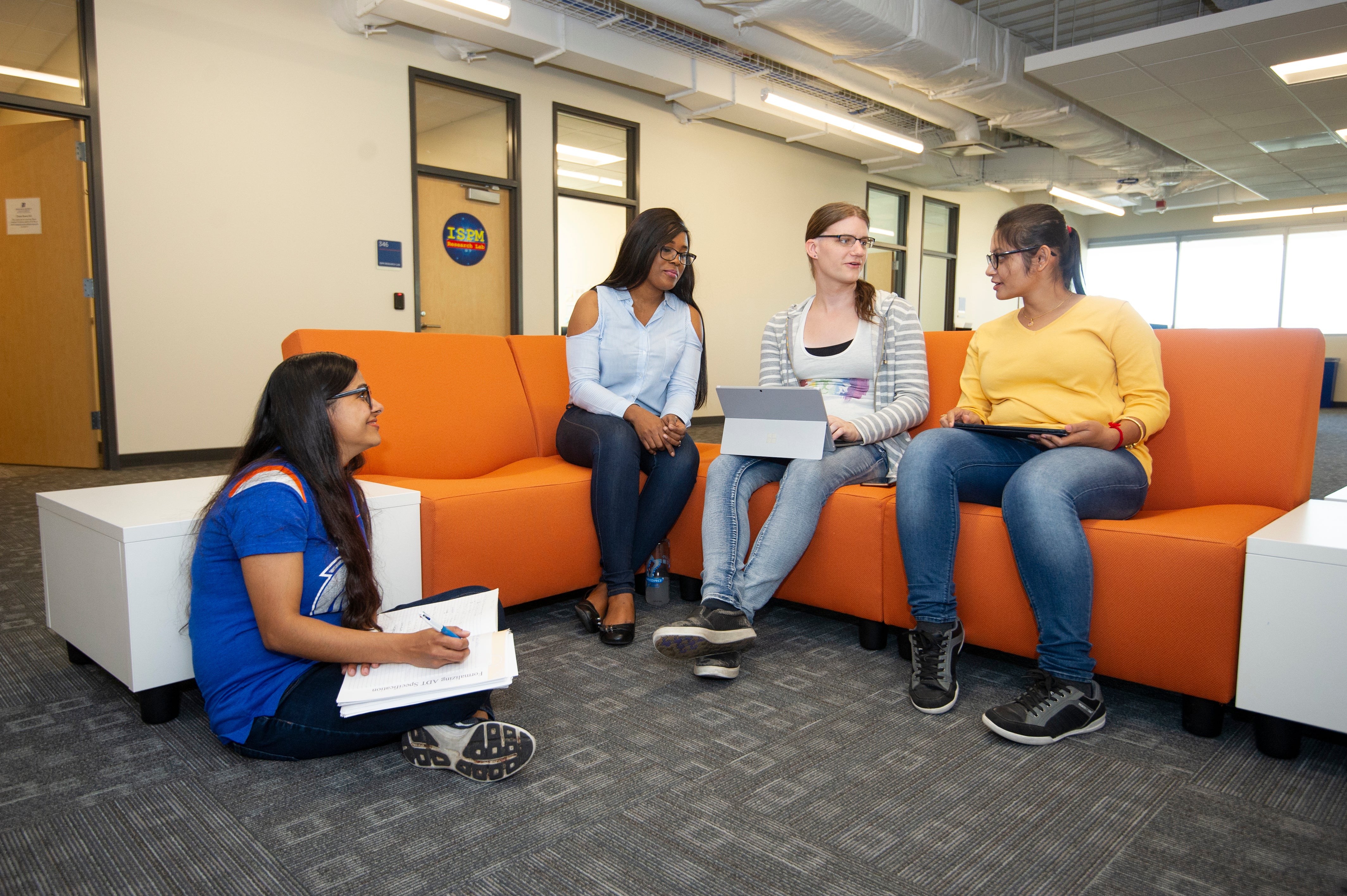 four students work together in a group