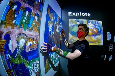 visitor interacting with art exhibit