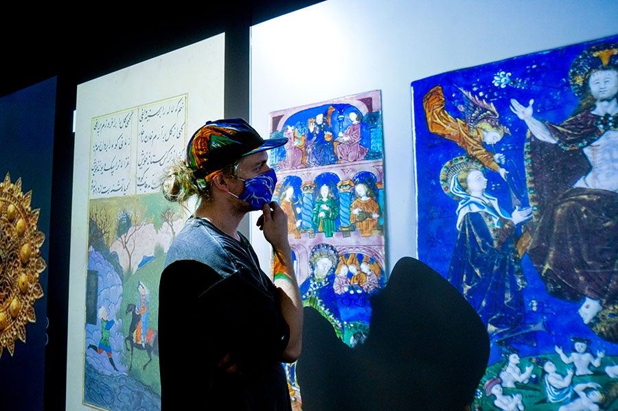 visitor observing art exhibit