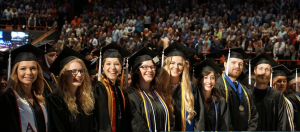 Image of a row of standing linguistics graduates at commencement