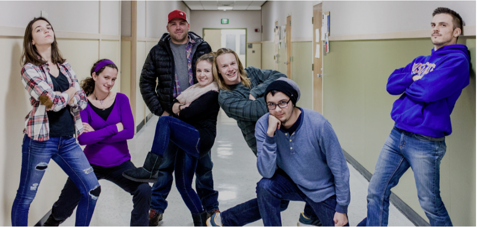 Group of students posing casually in hallway